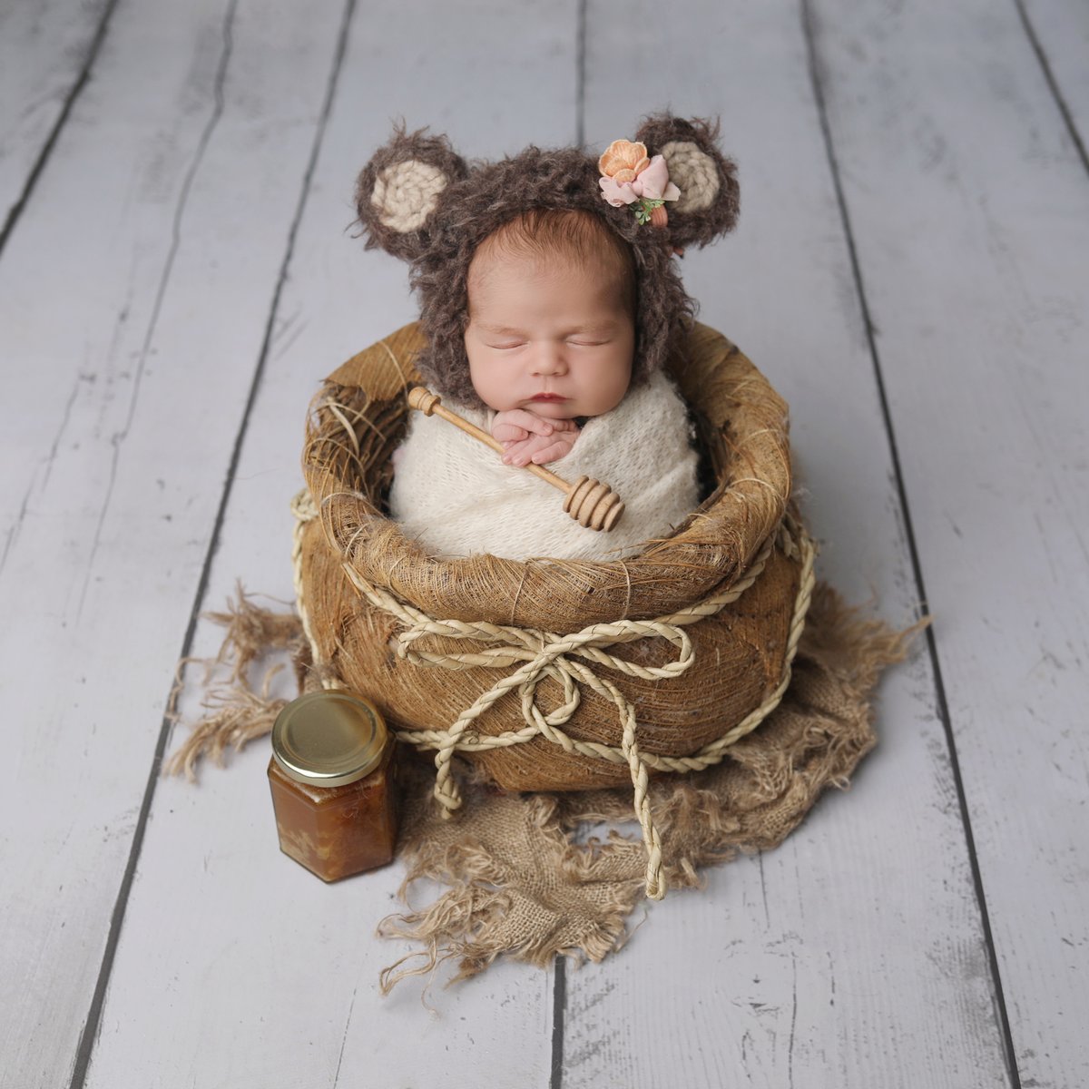 baby with bear costume on posing for a baby art studios photo