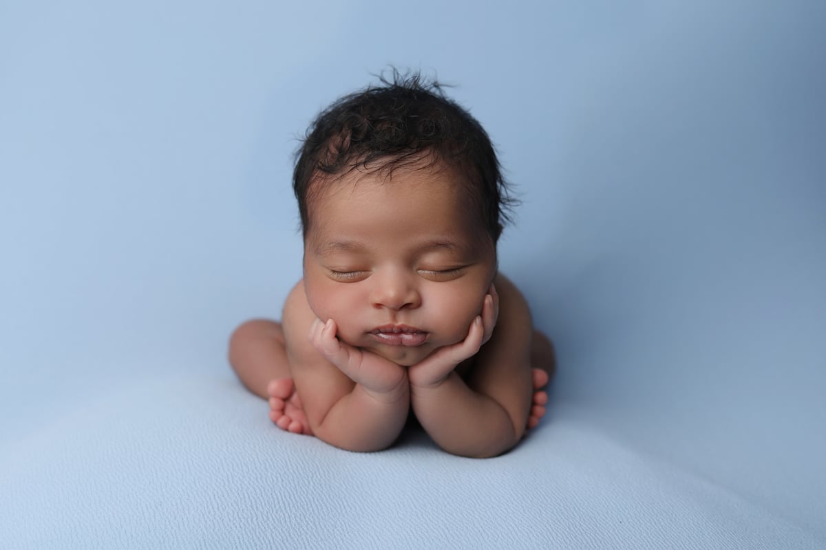 baby posing on a blue soft background