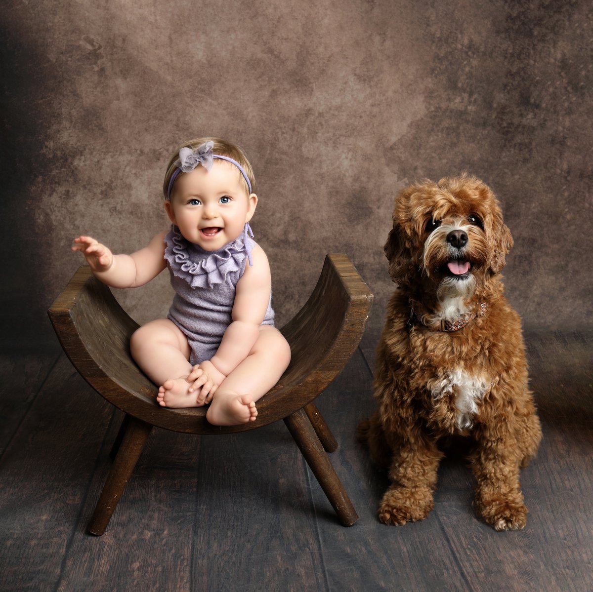 baby and dog sitting together during professional photoshoot