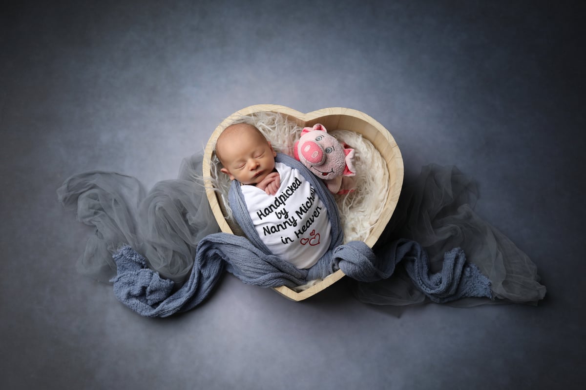 baby in heart-shaped box for photoshoot
