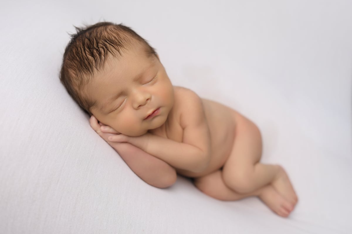 baby sleeping in professional photoshoot with baby art studios