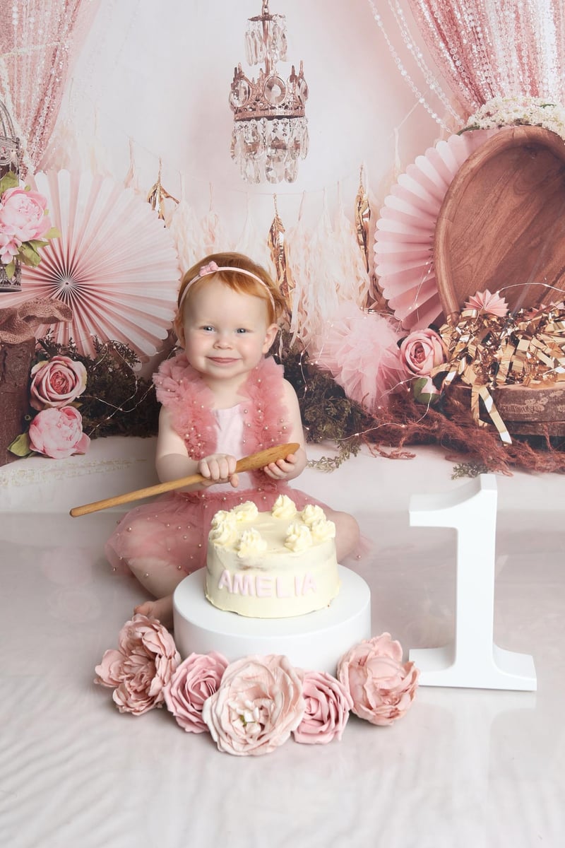 baby posing for a cake smash photo at one years old