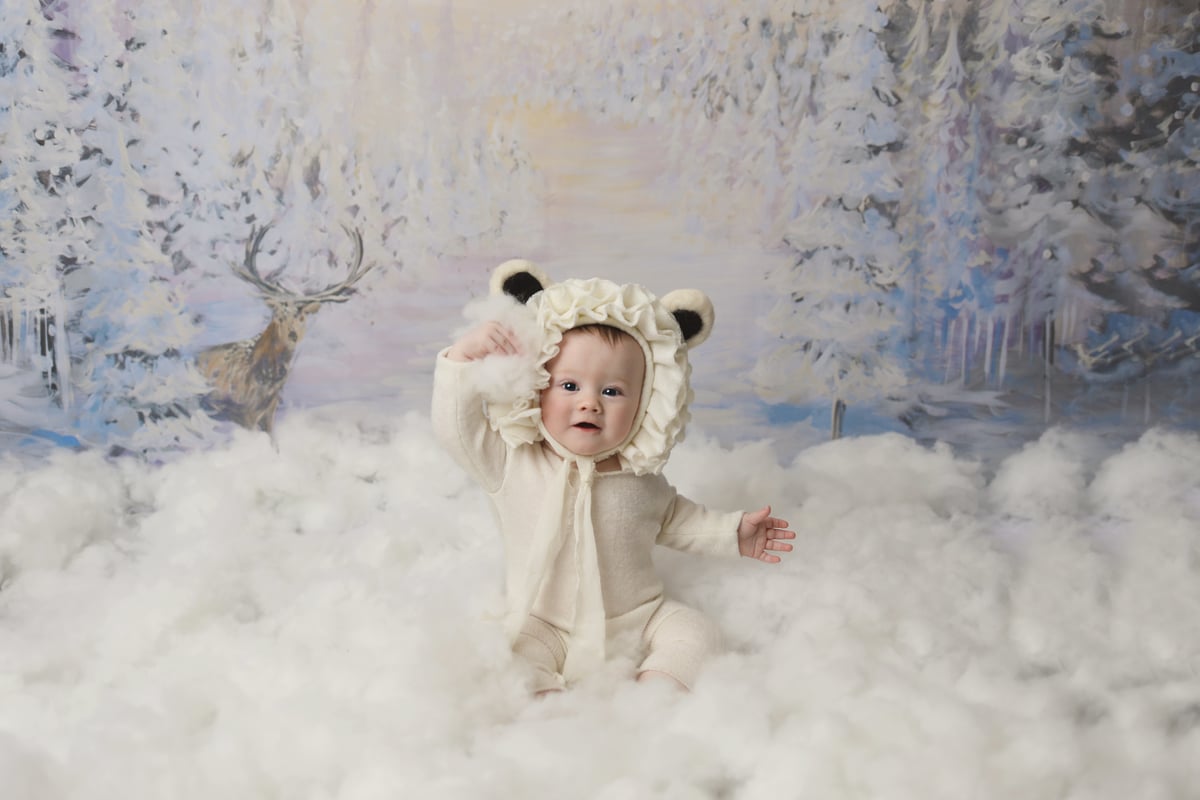 baby playing in cotton wool snow during a photoshoot